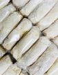 Individually wrapped cheese rolls arranged together