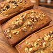 Three freshly baked banana walnut loaves with walnut topping
