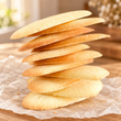 Stack of thin golden lengua de gato butter cookies
